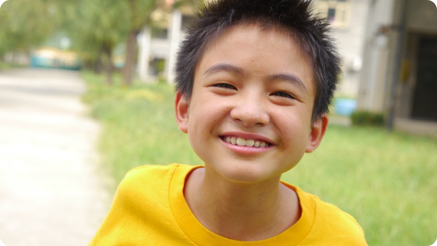 Young boy smiling in a photo