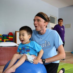 physical therapy intern makes therapy fun for young boy