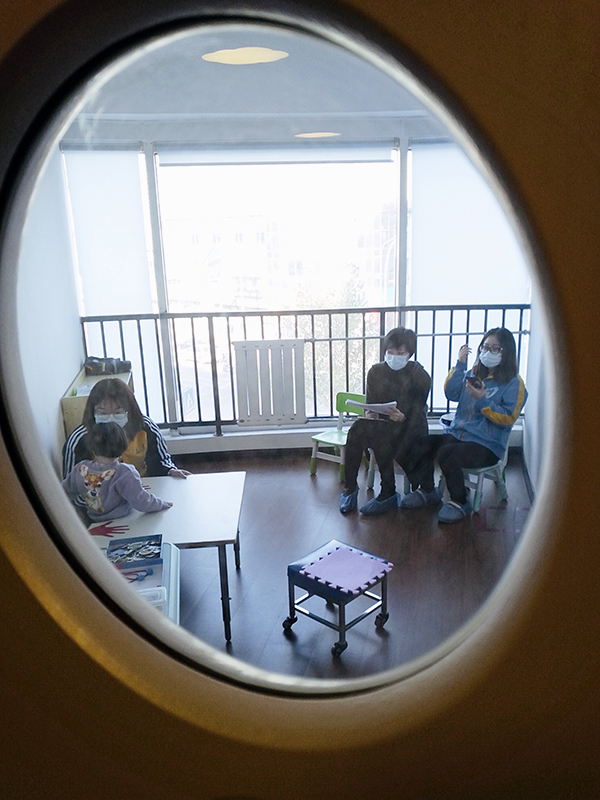 peek through window at therapy training session