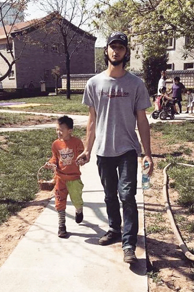 intern walking with small child