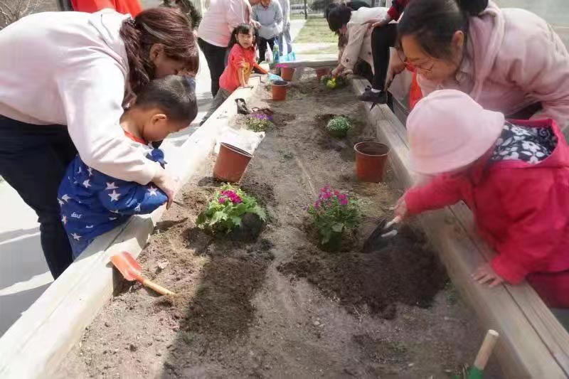 children and caregivers planting