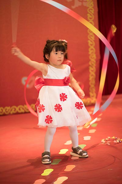 young orphan performs ribbon dance for children's day