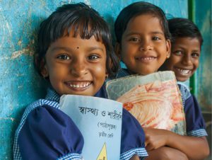 schoolchildren in India holding school folders