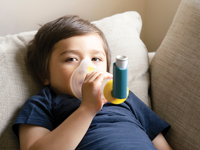 boy using asthma inhaler stockphoto