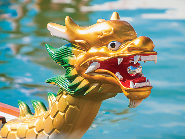 Dragon Head on the front of a dragon boat on the water