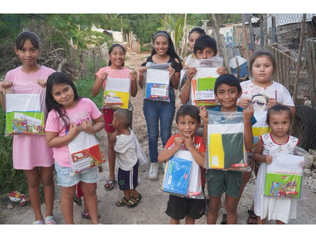 group of mexican school children receiving free school supplies