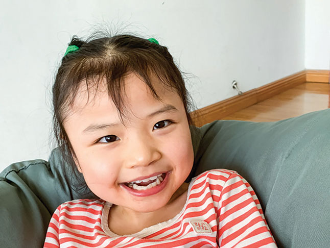 young Chinese orphan with big smile
