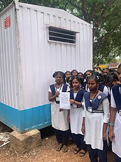 schoolgirls in India outside newly completed bathroom