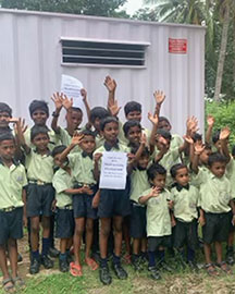 schoolboys in India outside newly constructed bathroom