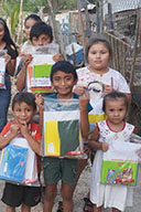 group of school children in Mexico holding gifted school supplies