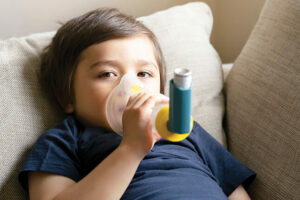 young child using an asthma rescue inhaler