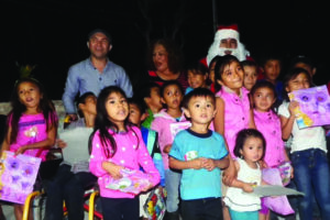 Smiling group of children with disabilities in Mexico enjoy a Christmas Festival, complete with gifts from Santa!