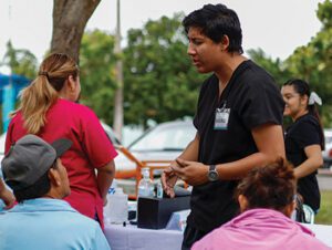 health care worker discuses health screening with mexican woman